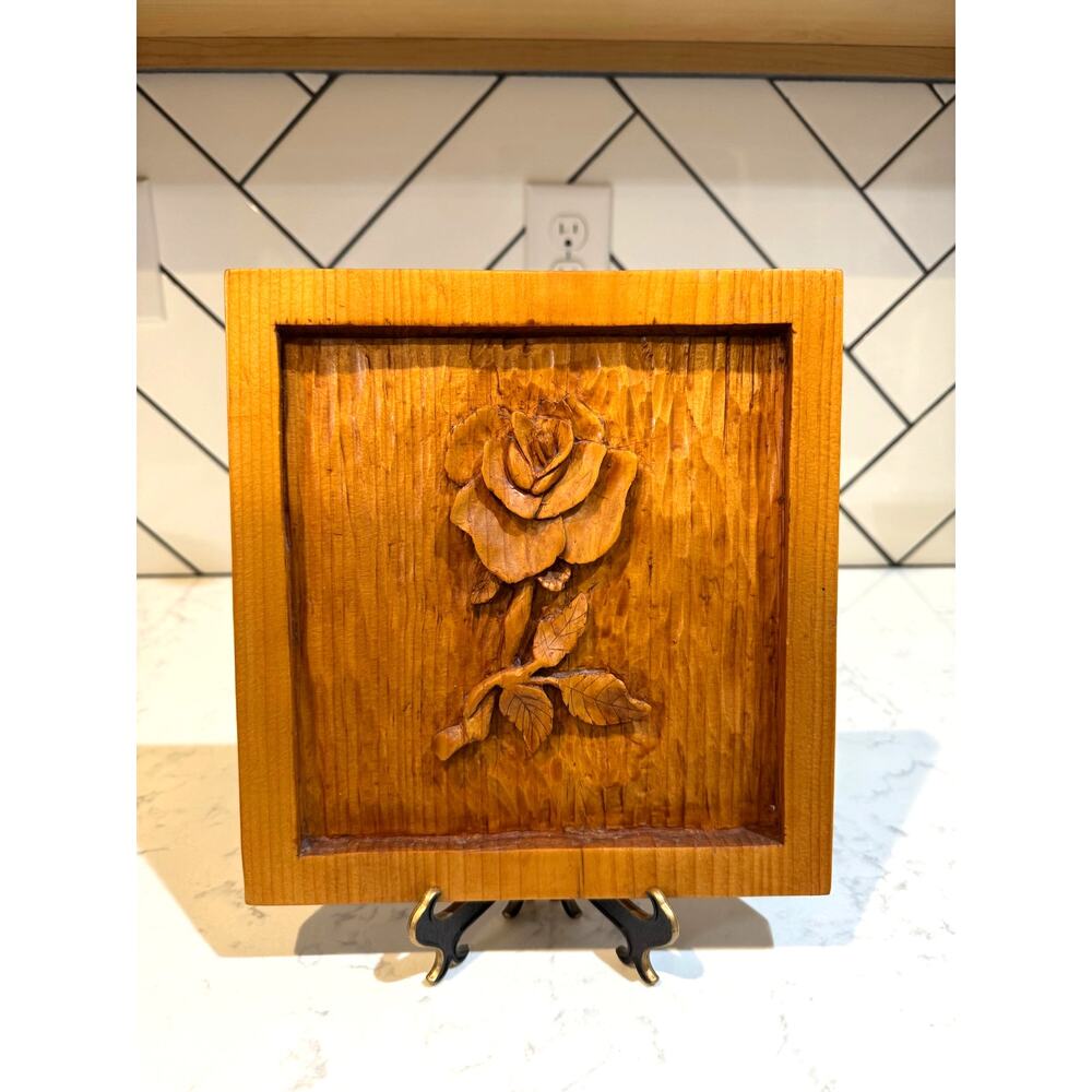 relief wood carving of a raised rose and stem signed Loraine Silva 2004 romance